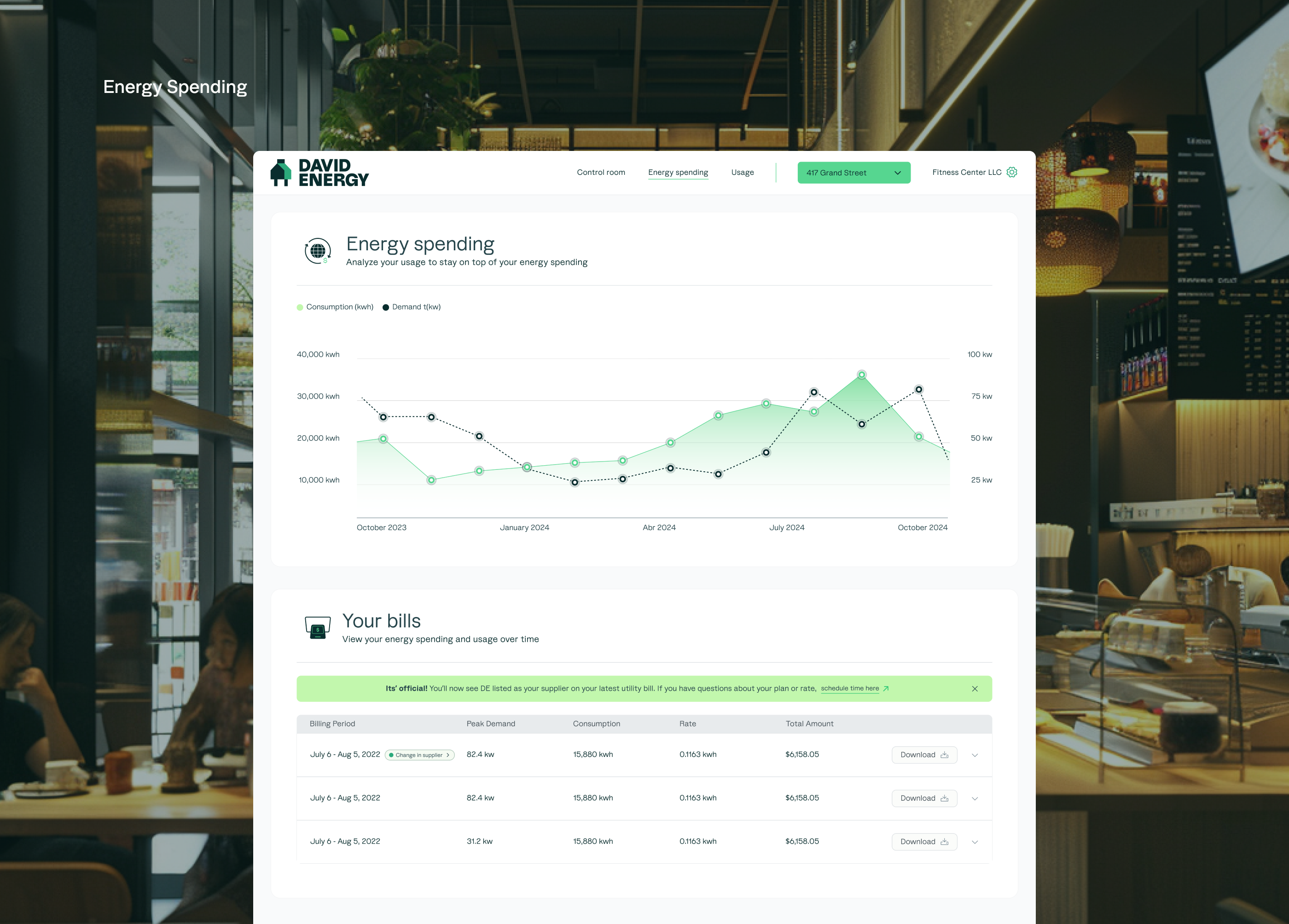 Energy Spending dashboard — MacBook in restaurant setting showing consumption and demand chart with billing table